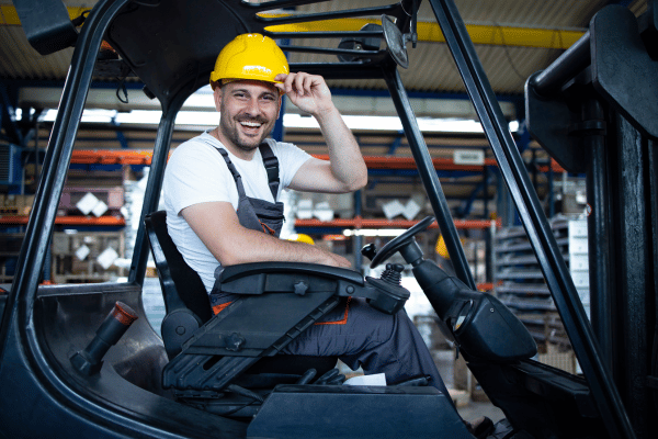 Worker sitting on electric forklift